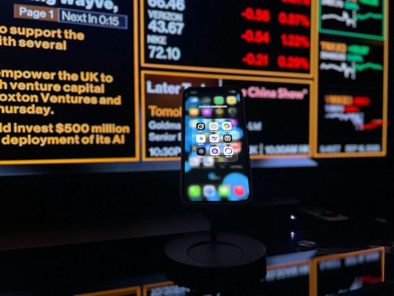 No-Code Ai Agent Builders (2026) – The Complete Guide 5 Smartphone Displaying Ai Apps In Front Of A Financial Data Screen In London.