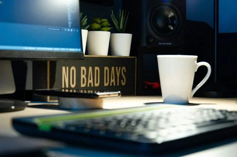 White ceramic mug beside black computer keyboard