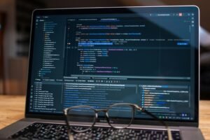 Laptop screen displaying lines of code with glasses.