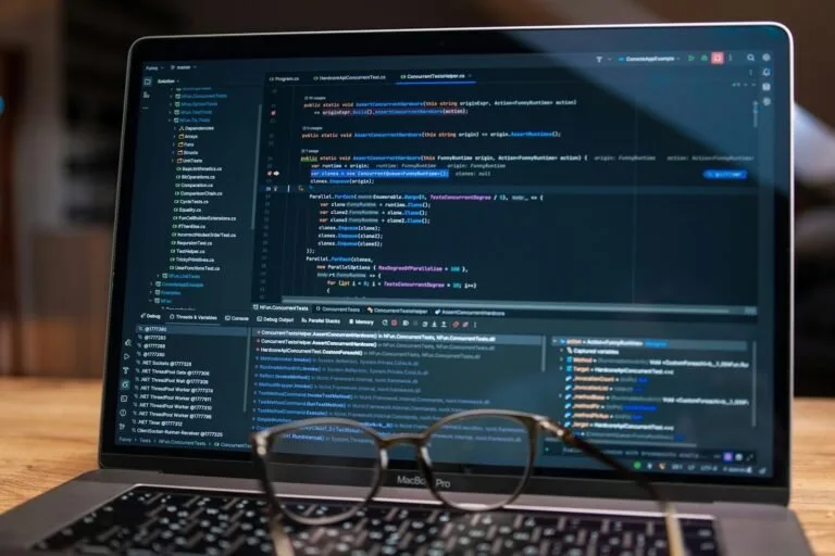 Laptop screen displaying lines of code with glasses.