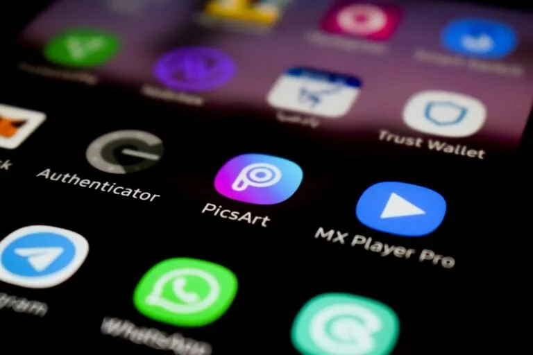 A close up of a cell phone with different app icons