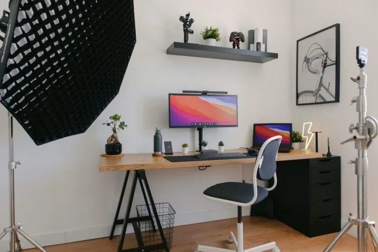 Black flat screen tv turned on on white wall