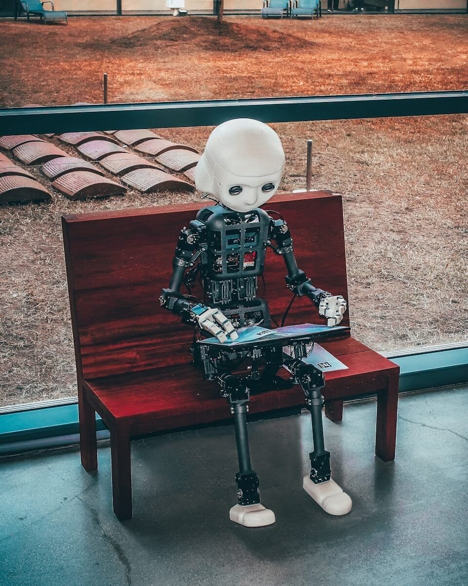 Autogen Review (2026) – Features, Pricing, Pros &Amp; Cons 1 | Ai Agent Black And White Robot Toy On Red Wooden Table